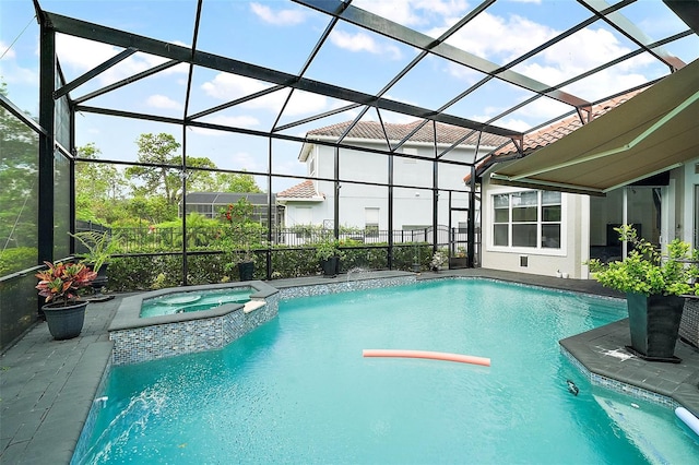 view of pool with glass enclosure, a pool with connected hot tub, and a patio area