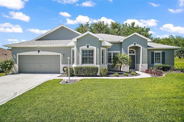 ranch-style house with an attached garage, driveway, stucco siding, and a front lawn