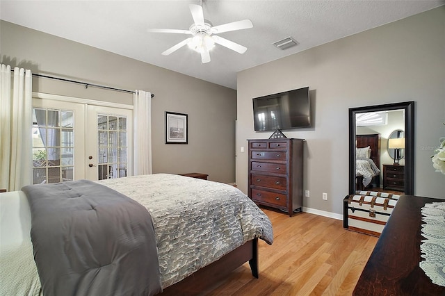 bedroom featuring access to outside, ceiling fan, light wood-type flooring, visible vents, and french doors
