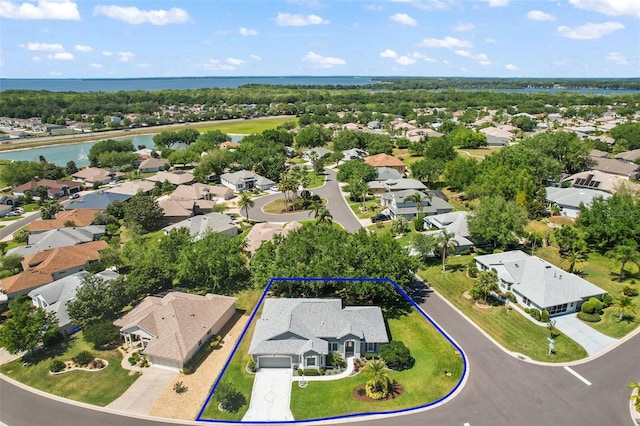 drone / aerial view with a water view and a residential view