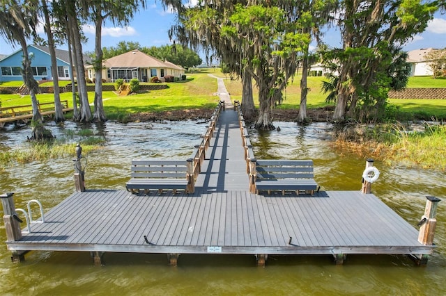 dock area featuring a yard and a water view