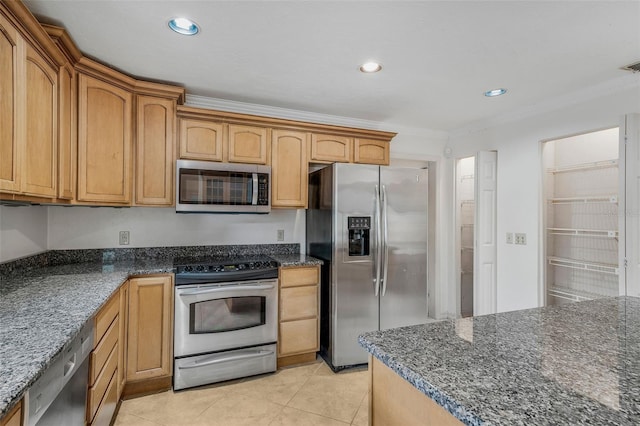 8640 E Henderson Trl, Inverness, FL 34450 - kitchen featuring stainless steel appliances, dark stone counters, light tile patterned flooring, visible vents, and crown molding