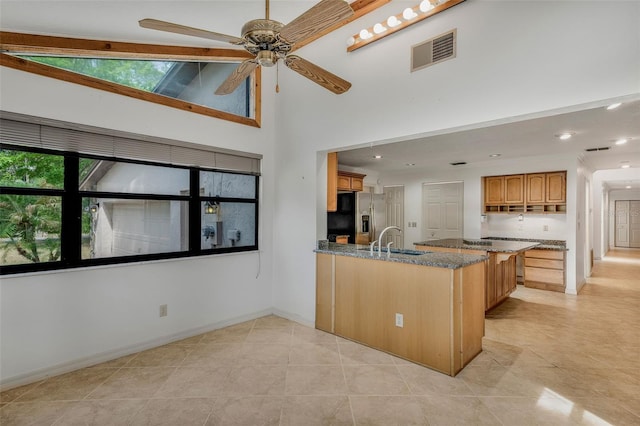 8640 E Henderson Trl, Inverness, FL 34450 - kitchen with a ceiling fan, a sink, a peninsula, visible vents, and stainless steel refrigerator with ice dispenser