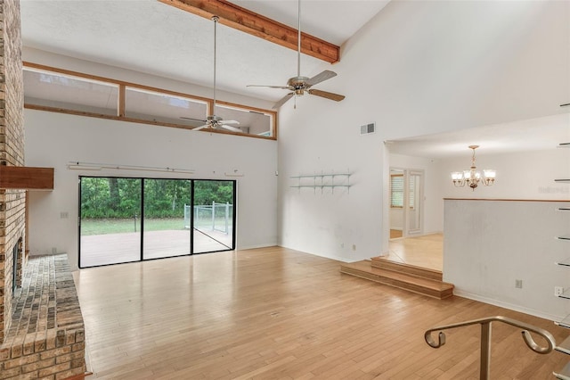 8640 E Henderson Trl, Inverness, FL 34450 - unfurnished living room featuring beam ceiling, a towering ceiling, visible vents, ceiling fan with notable chandelier, and wood-type flooring