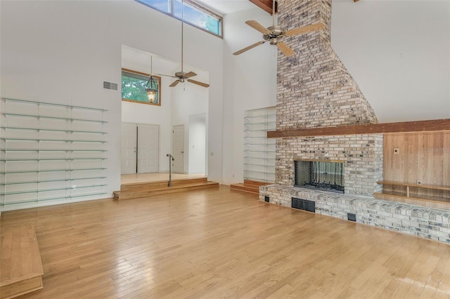 8640 E Henderson Trl, Inverness, FL 34450 - unfurnished living room featuring ceiling fan, wood finished floors, a towering ceiling, and visible vents