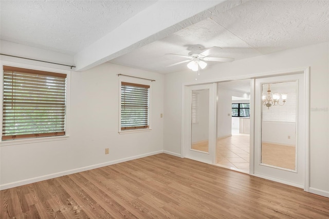 8640 E Henderson Trl, Inverness, FL 34450 - spare room with light wood-style flooring, a textured ceiling, baseboards, and ceiling fan with notable chandelier