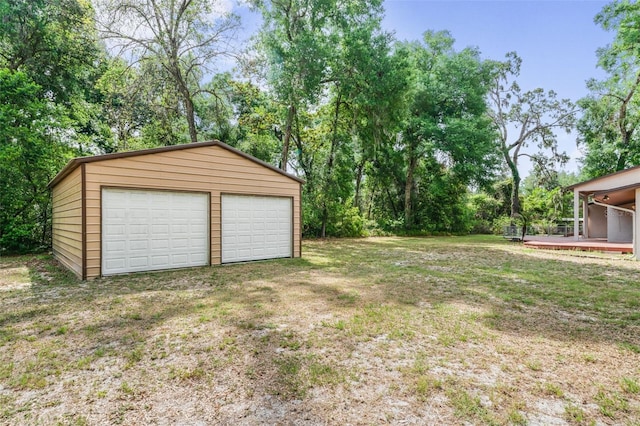 8640 E Henderson Trl, Inverness, FL 34450 - view of yard featuring an outbuilding, a deck, and a detached garage