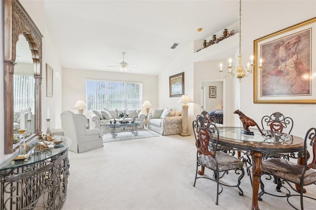 dining area with carpet flooring, visible vents, ceiling fan with notable chandelier, and vaulted ceiling