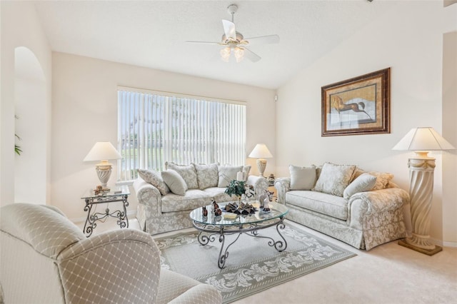 carpeted living room with baseboards, a ceiling fan, and lofted ceiling