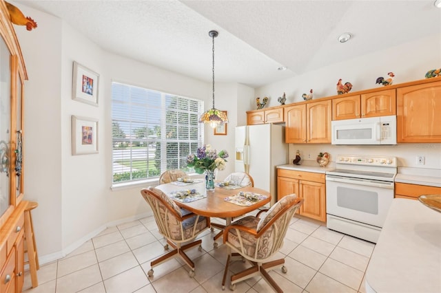 kitchen featuring light tile patterned floors, white appliances, a textured ceiling, light countertops, and hanging light fixtures