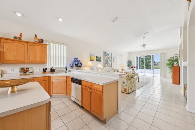 kitchen with open floor plan, a peninsula, stainless steel dishwasher, and visible vents