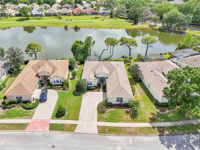 drone / aerial view featuring a water view and a residential view