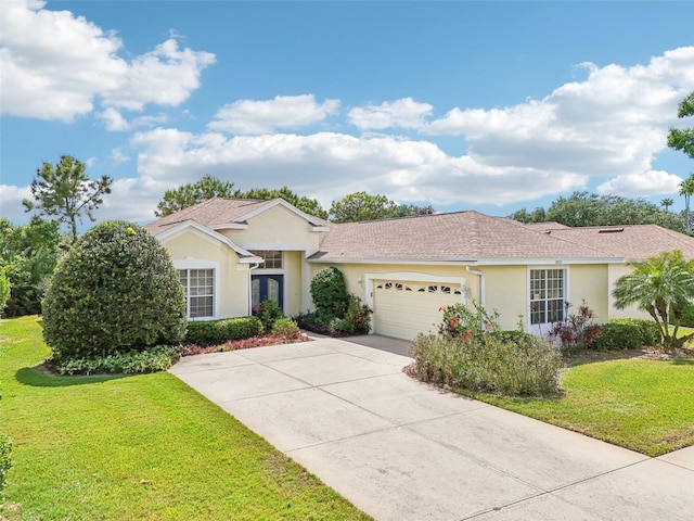 ranch-style house with an attached garage, concrete driveway, stucco siding, and a front yard