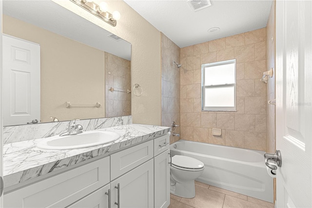 full bathroom featuring tile patterned flooring, vanity, toilet, visible vents, and washtub / shower combination