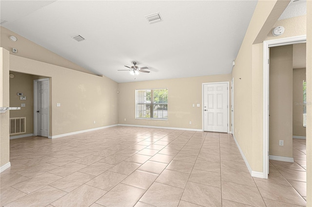 spare room with visible vents, lofted ceiling, and ceiling fan