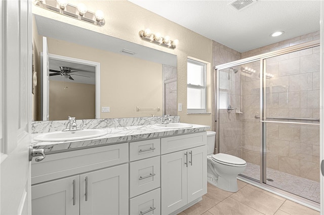full bathroom featuring tile patterned flooring, a sink, a stall shower, and visible vents