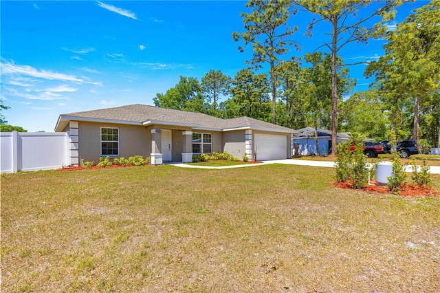 ranch-style house featuring a garage, fence, concrete driveway, and a front yard