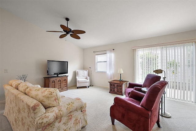 living area with light colored carpet, baseboards, a ceiling fan, and vaulted ceiling