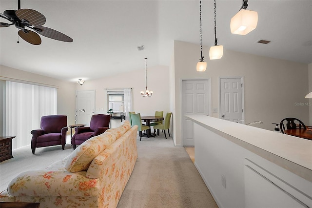 living room featuring light carpet, ceiling fan with notable chandelier, and lofted ceiling