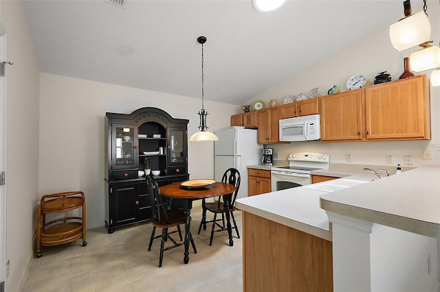 kitchen with white appliances, vaulted ceiling, light countertops, a sink, and decorative light fixtures