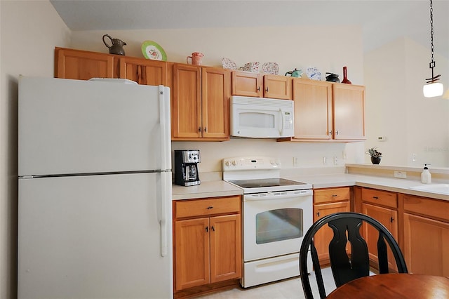 kitchen with pendant lighting, a sink, light countertops, and white appliances