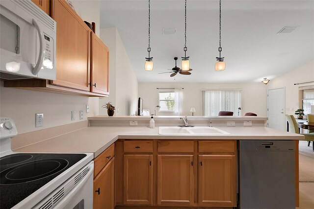 kitchen with white appliances, a peninsula, light countertops, ceiling fan, and a sink