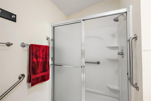full bathroom with a shower stall and vaulted ceiling