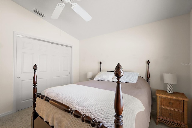 carpeted bedroom featuring a ceiling fan, a closet, vaulted ceiling, and visible vents