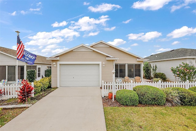 ranch-style home with an attached garage, fence, and driveway