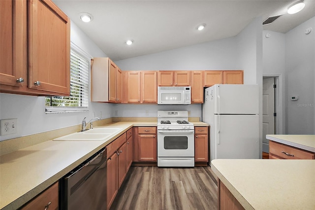2290 Due W Dr, The Villages, FL 32162 - kitchen featuring white appliances, visible vents, lofted ceiling, a sink, and wood finished floors