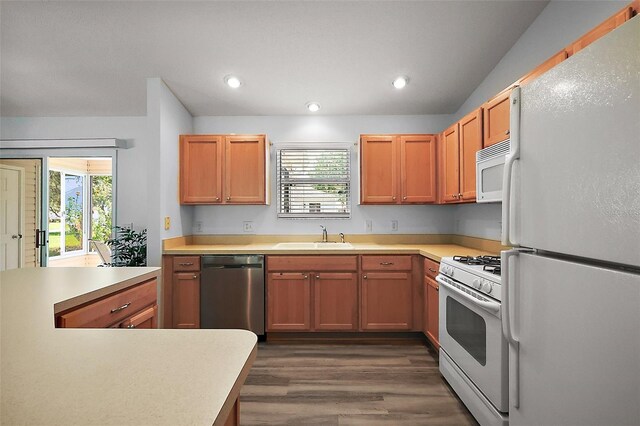 2290 Due W Dr, The Villages, FL 32162 - kitchen featuring recessed lighting, white appliances, light countertops, dark wood-type flooring, and a sink