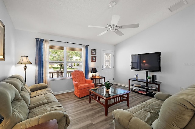 2290 Due W Dr, The Villages, FL 32162 - living area with baseboards, vaulted ceiling, visible vents, ceiling fan, and wood finished floors