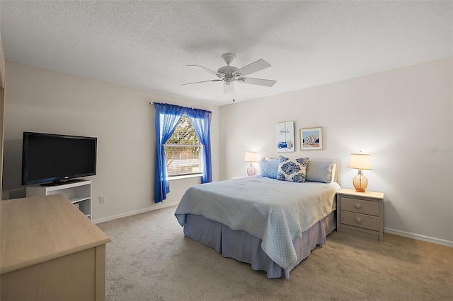 2290 Due W Dr, The Villages, FL 32162 - bedroom with baseboards, a ceiling fan, light carpet, and a textured ceiling