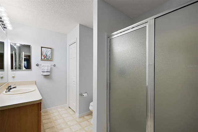2290 Due W Dr, The Villages, FL 32162 - bathroom featuring toilet, a textured ceiling, vanity, tile patterned floors, and a stall shower