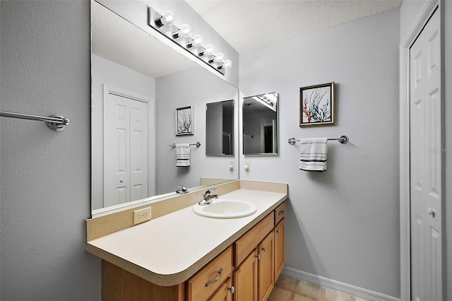 2290 Due W Dr, The Villages, FL 32162 - bathroom featuring a closet, baseboards, vanity, and a textured ceiling
