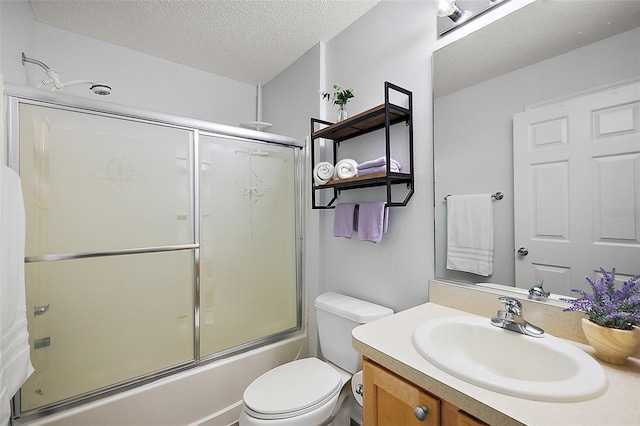2290 Due W Dr, The Villages, FL 32162 - full bath featuring toilet, vanity, shower / bath combination with glass door, and a textured ceiling