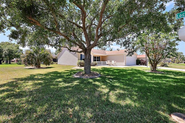 2290 Due W Dr, The Villages, FL 32162 - exterior space featuring a front yard and a garage