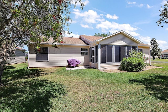 2290 Due W Dr, The Villages, FL 32162 - rear view of property with a yard, a sunroom, and roof with shingles