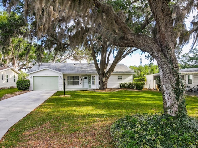 view of front of home with a front yard, driveway, and an attached garage