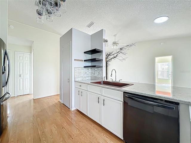 kitchen with a sink, light wood-style floors, dishwasher, white cabinets, and a peninsula