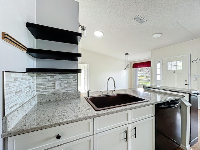 kitchen featuring a sink, open shelves, a peninsula, black dishwasher, and decorative backsplash