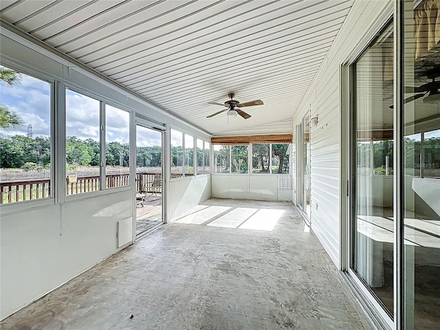 unfurnished sunroom with ceiling fan