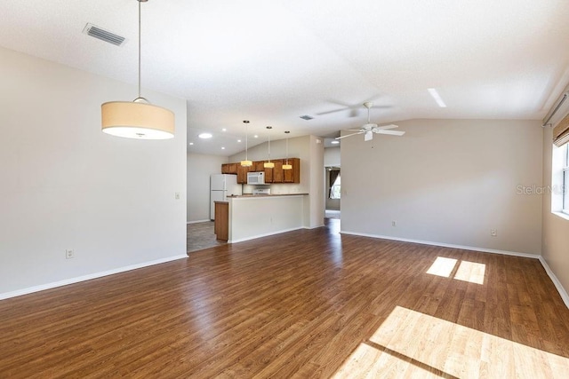 1667 Osprey Ave, The Villages, FL 32162 - unfurnished living room with a wealth of natural light, lofted ceiling, ceiling fan, and dark wood-type flooring