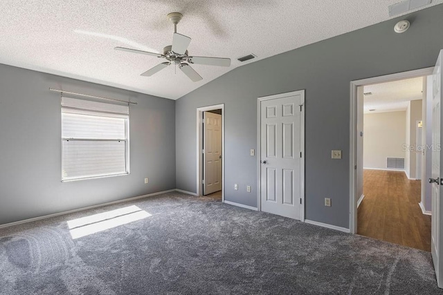 1667 Osprey Ave, The Villages, FL 32162 - unfurnished bedroom with a textured ceiling, visible vents, carpet, and vaulted ceiling