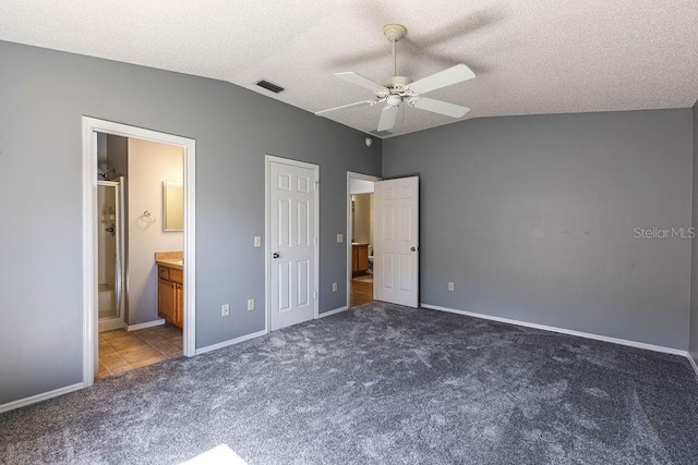 1667 Osprey Ave, The Villages, FL 32162 - unfurnished bedroom featuring lofted ceiling, visible vents, carpet, and a textured ceiling
