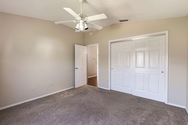 1667 Osprey Ave, The Villages, FL 32162 - unfurnished bedroom featuring lofted ceiling, a textured ceiling, carpet floors, visible vents, and a closet