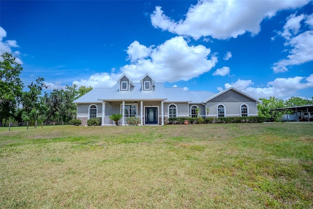 15141 Farm Rd, Groveland, FL 34736 - view of front facade featuring covered porch, a front yard, and metal roof