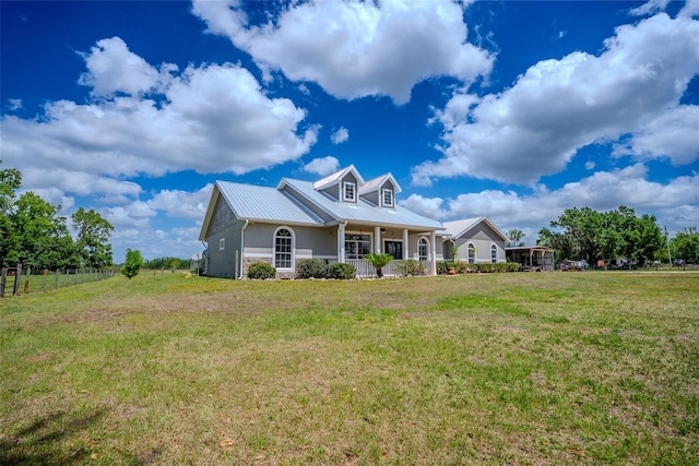15141 Farm Rd, Groveland, FL 34736 - view of front facade featuring a porch, metal roof, fence, and a front lawn