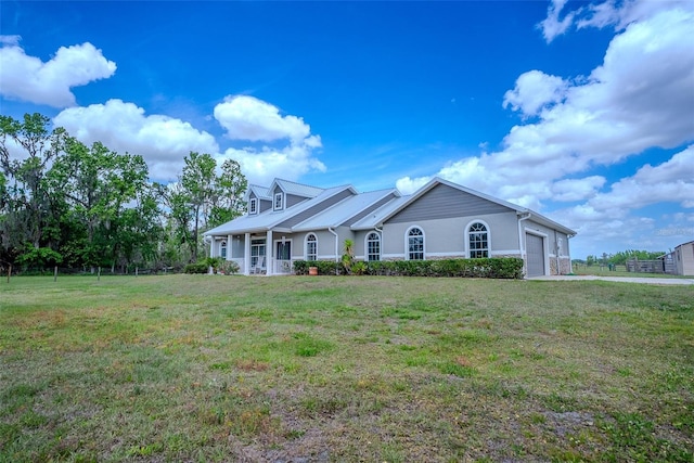 15141 Farm Rd, Groveland, FL 34736 - view of front facade with a front yard, covered porch, and an attached garage