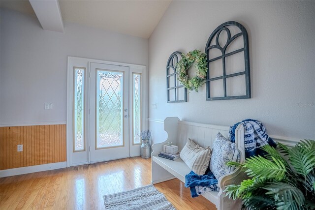 15141 Farm Rd, Groveland, FL 34736 - foyer featuring a wainscoted wall, vaulted ceiling, wood finished floors, and a healthy amount of sunlight
